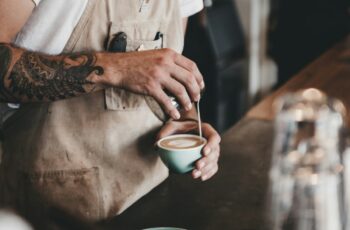 Barista making coffee at a cycling cafe