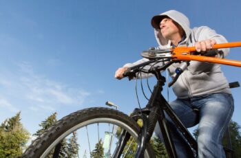 Picture of bike thief with lock cutters escaping on stolen bike.