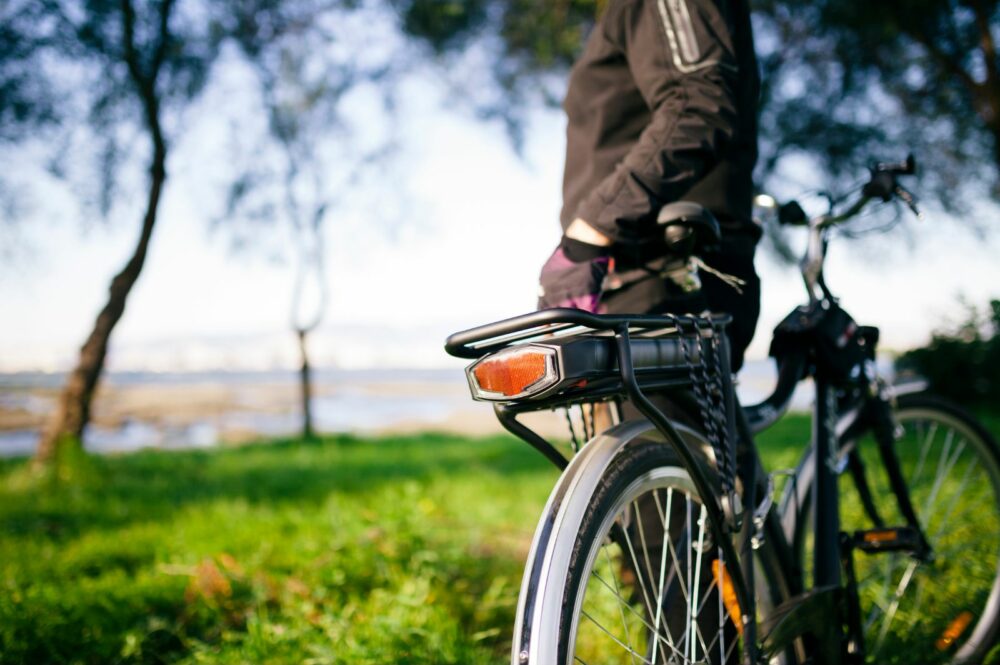 Picture of man leaning on e-bike.